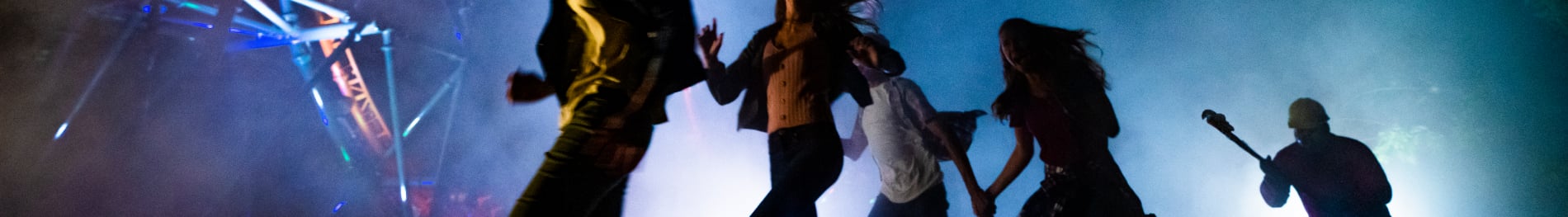 People running away from a scare-actor at Busch Gardens Howl-O-Scream